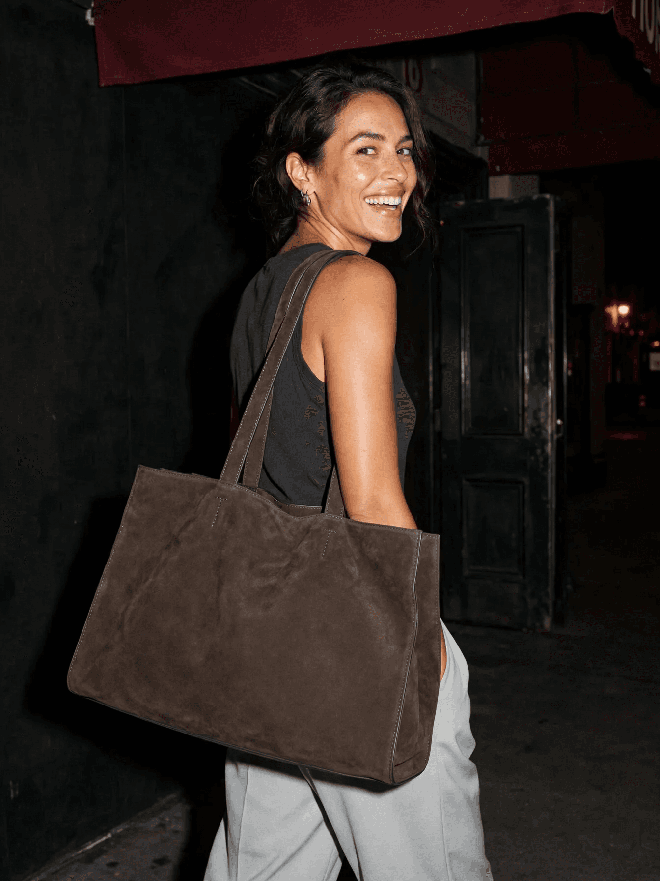Woman Carrying Suede Tote at Night example 28