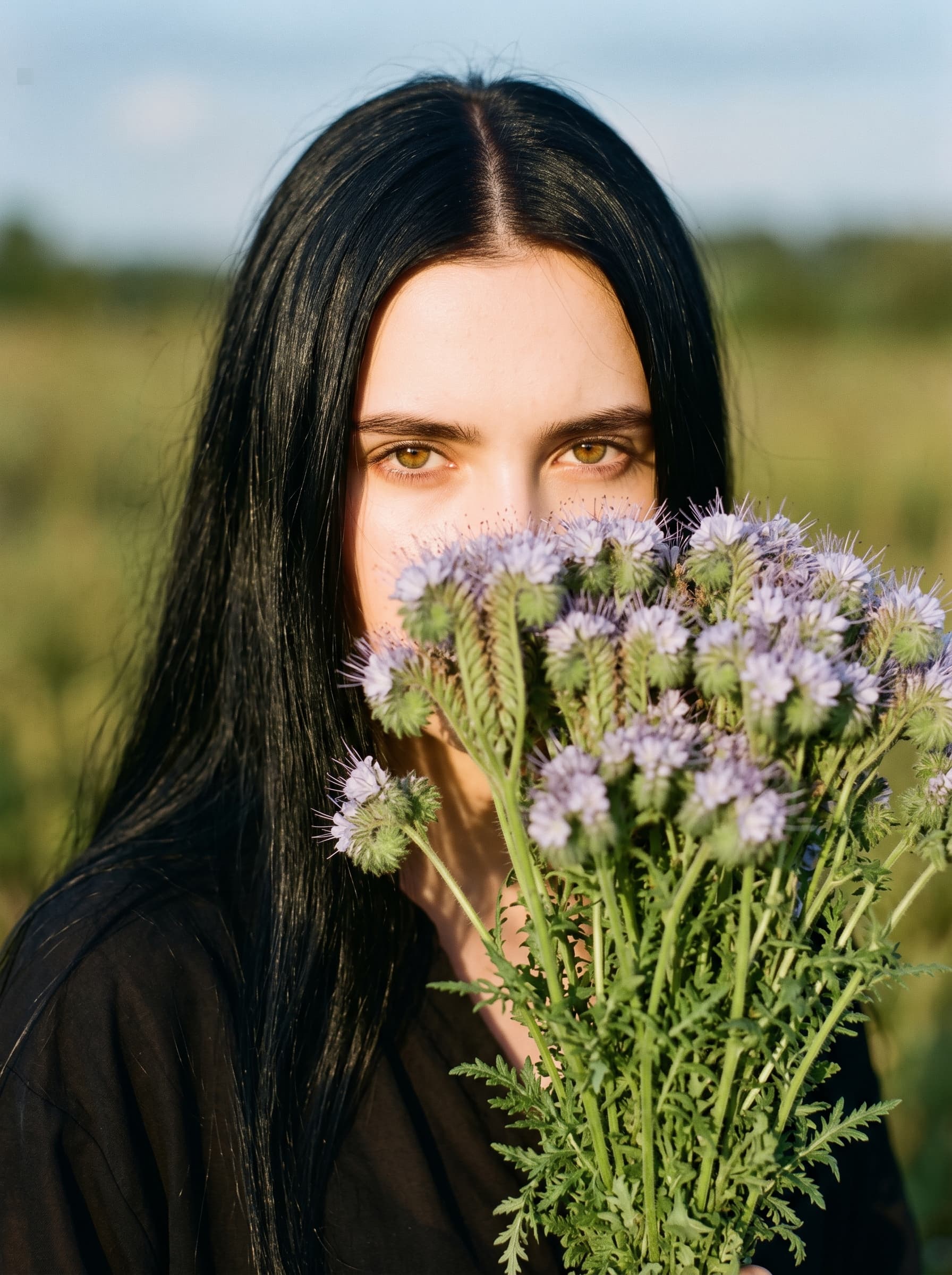 Woman Holding Flowers in Sunny Field example 5
